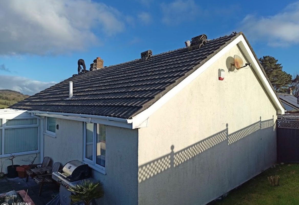 Clean concrete tiled bungalow roof after professional moss removal and roof cleaning