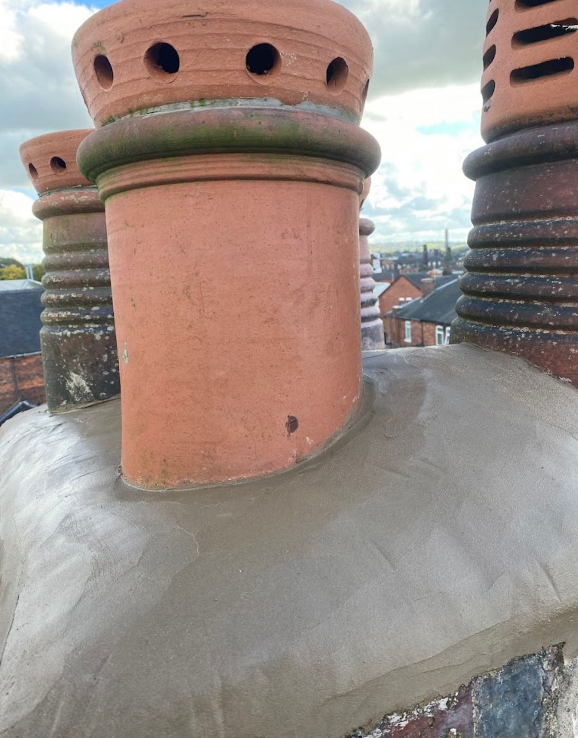 Rebuilt chimney stack with re-haunched flaunching and clay pots after chimney repair work by SL Roofing Services